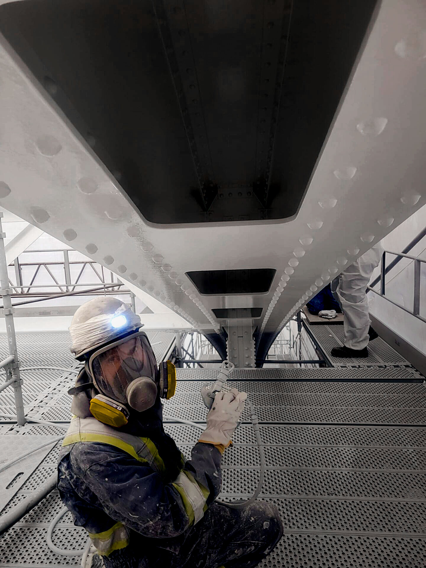 Industrial painter painting bridge