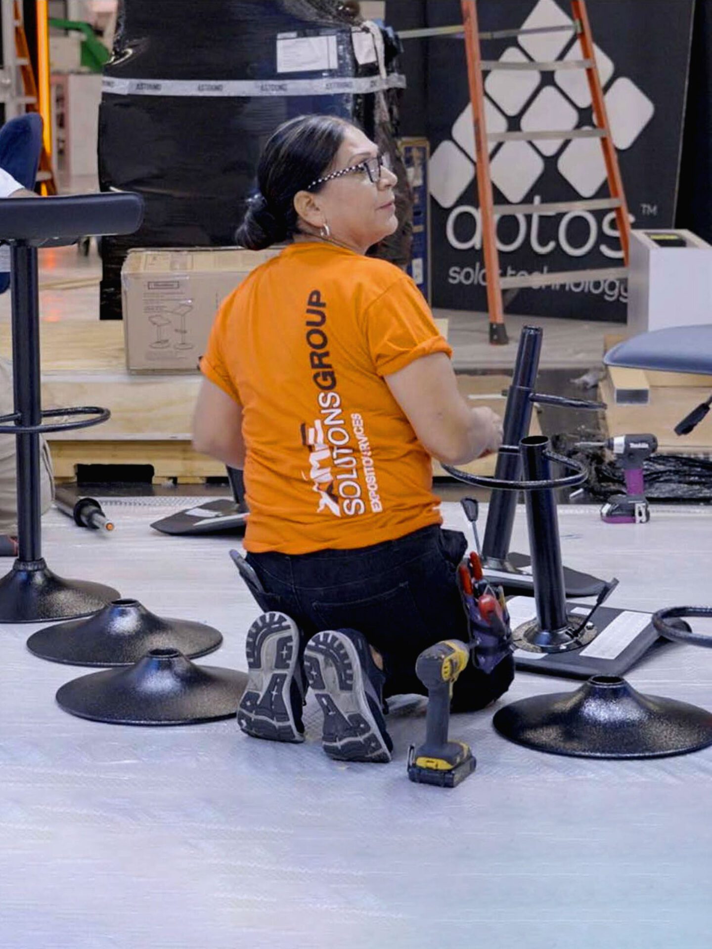 Trade show worker assembling stage